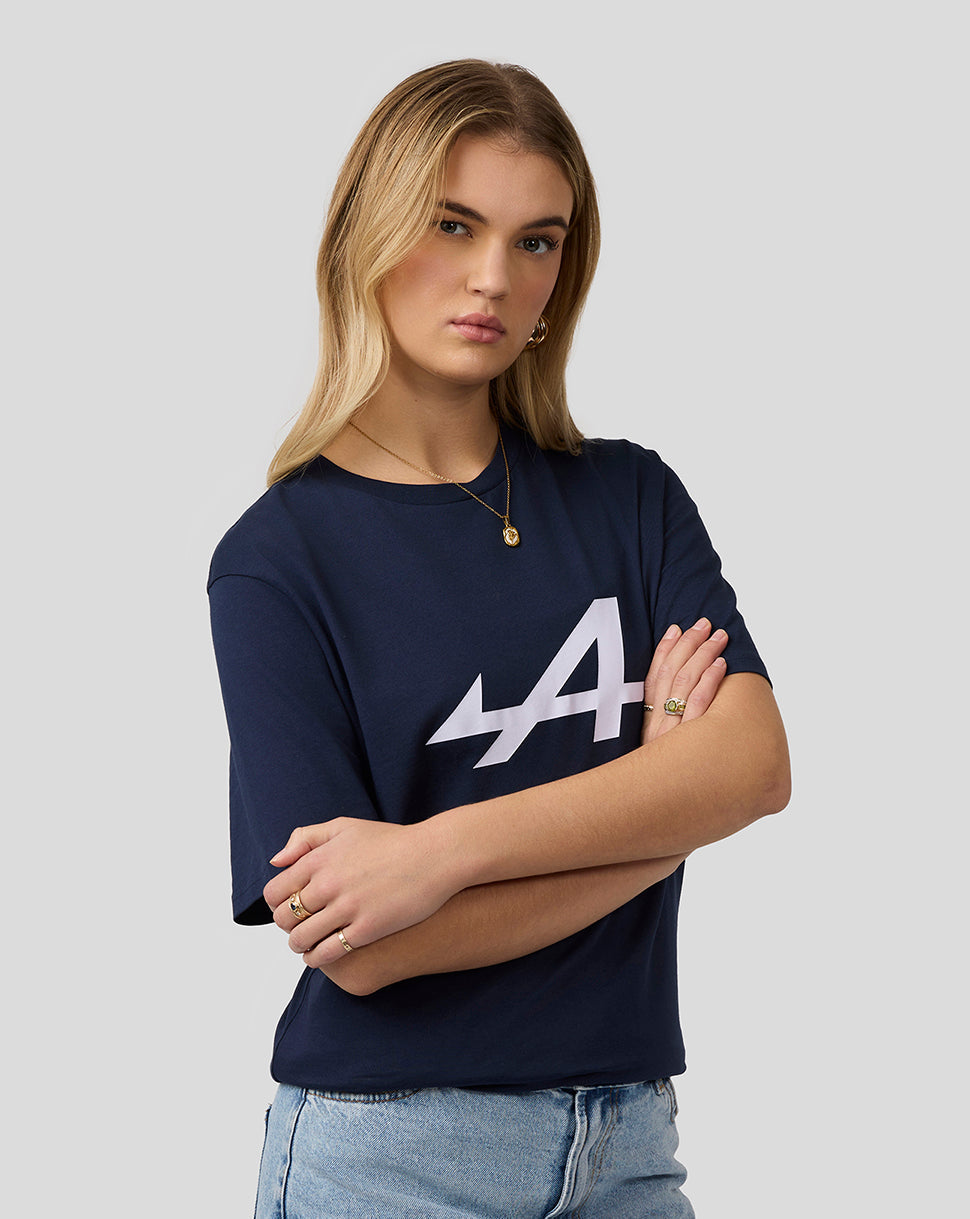 Female model in navy Alpine Core Essentials T-Shirt with large white logo, arms crossed