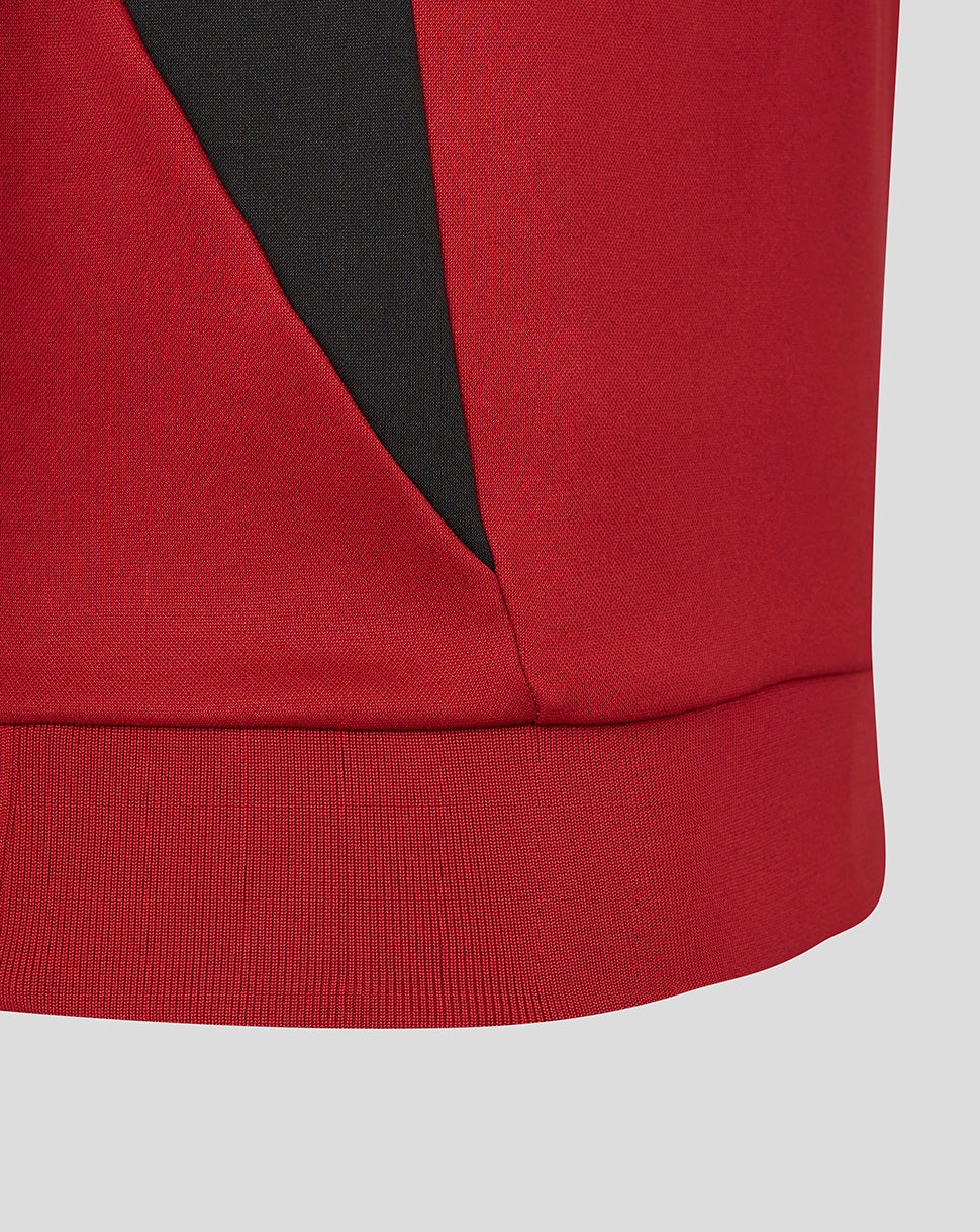 Hem detail of red Saracens training sweatshirt with black panel accent.