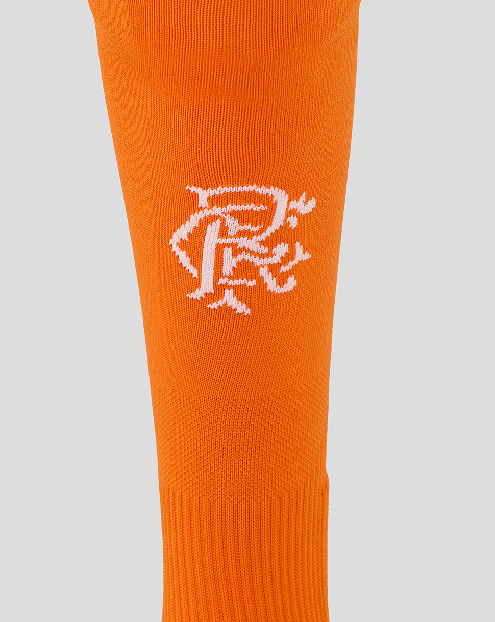 Close-up of orange Rangers sock with white scroll crest on the shin.