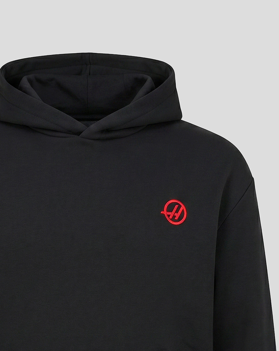 Black Haas Team hoodie close up with red circular monogram on chest and hood