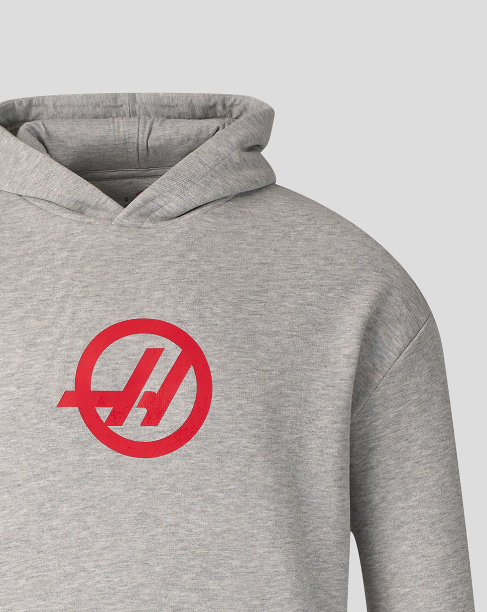 Close-up of heather grey hoodie fabric with red Haas logo on the chest area