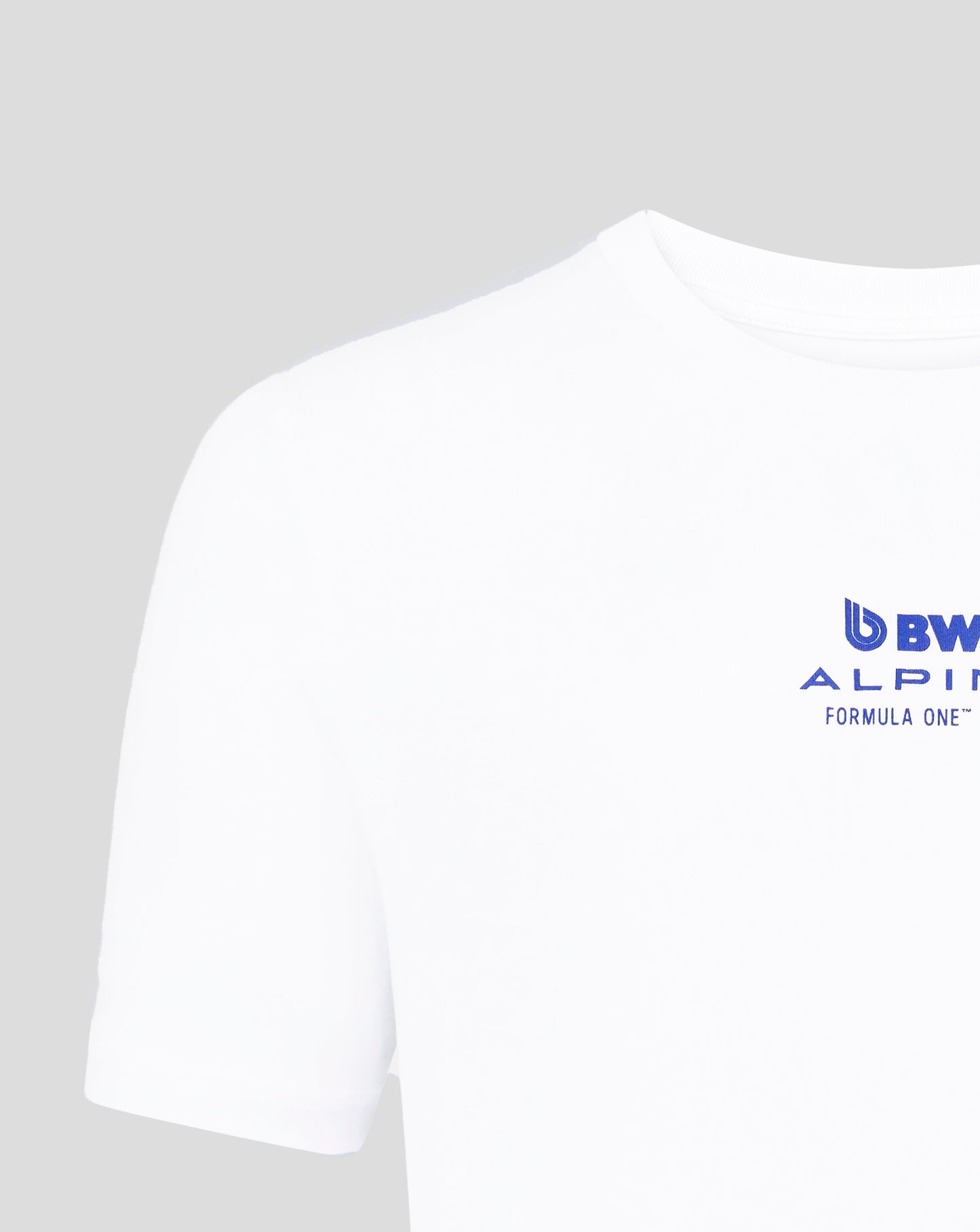 Close-up of a white Core Driver T shirt with a blue BWT Alpine logo near the lower chest.