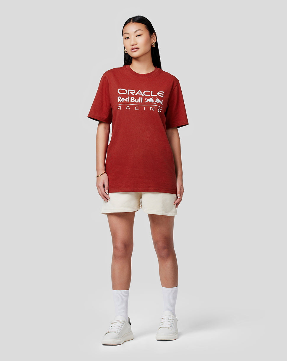 Woman wearing Oracle Red Bull Racing Winery red tee with beige shorts and white sneakers
