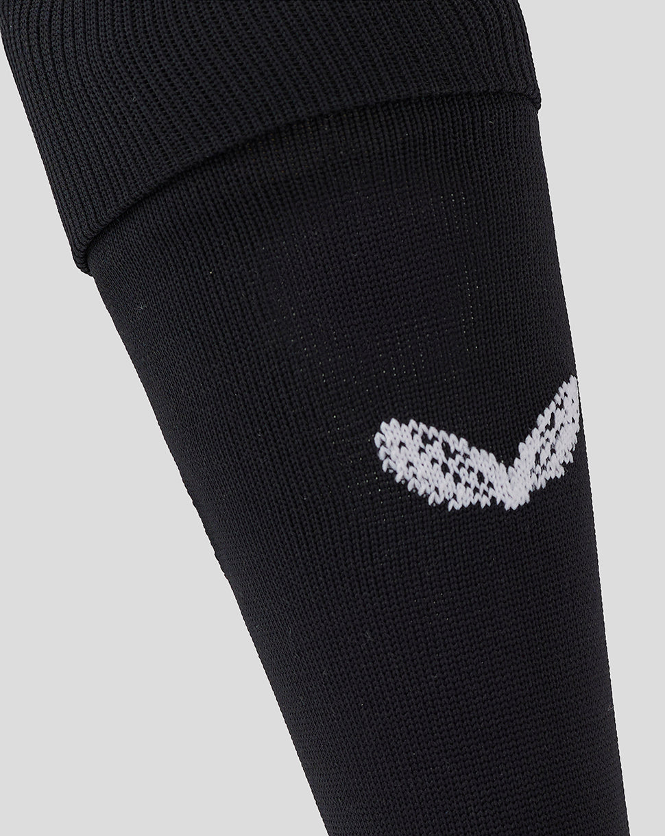 Detail of the white Saracens emblem on the black knee-high sock