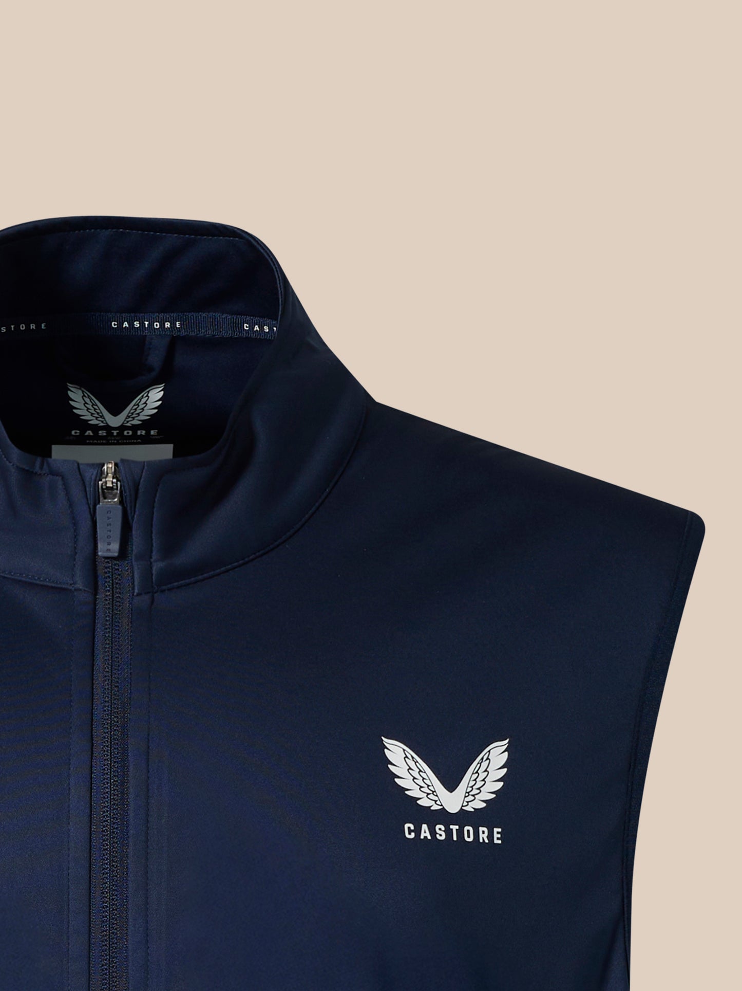 Navy softshell gilet close up of collar with full front zip and branded neck tape