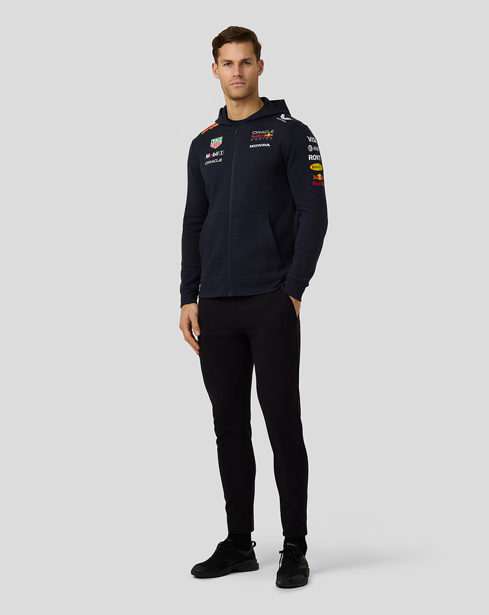 Male model wearing navy Oracle Red Bull Racing unisex team hoodie with full front zip and team logos on chest and sleeve.