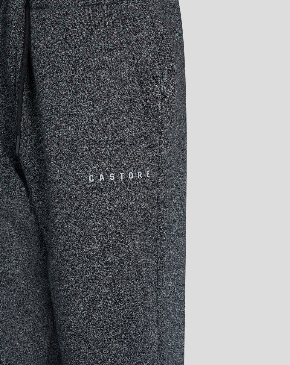 Close up of charcoal marl joggers fabric with Castore branding on the thigh.