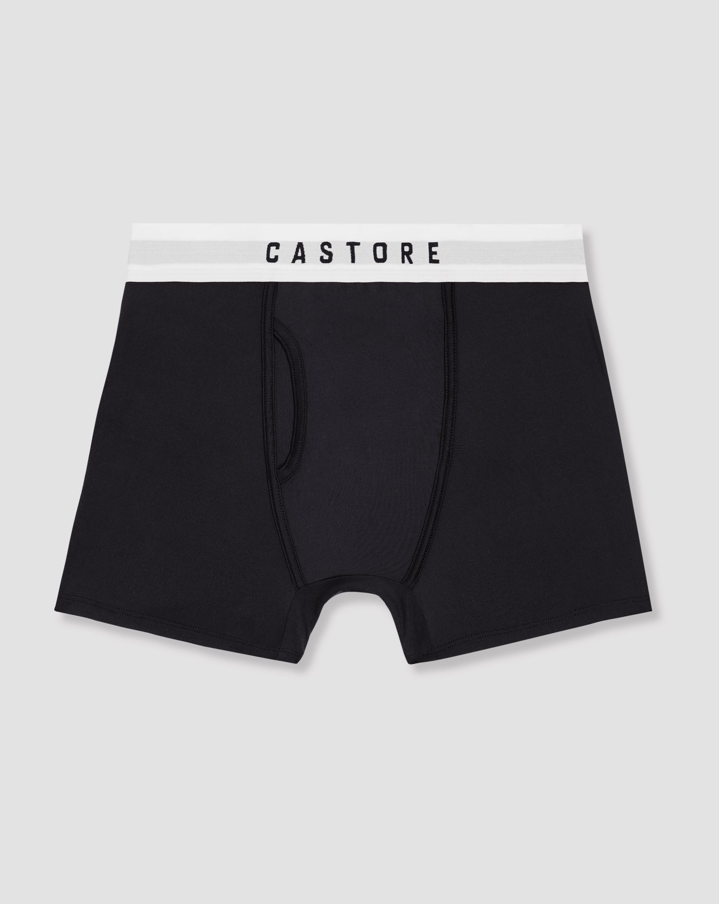 Close up of navy boxer shorts with a white CASTORE waistband shown in a stacked three pack