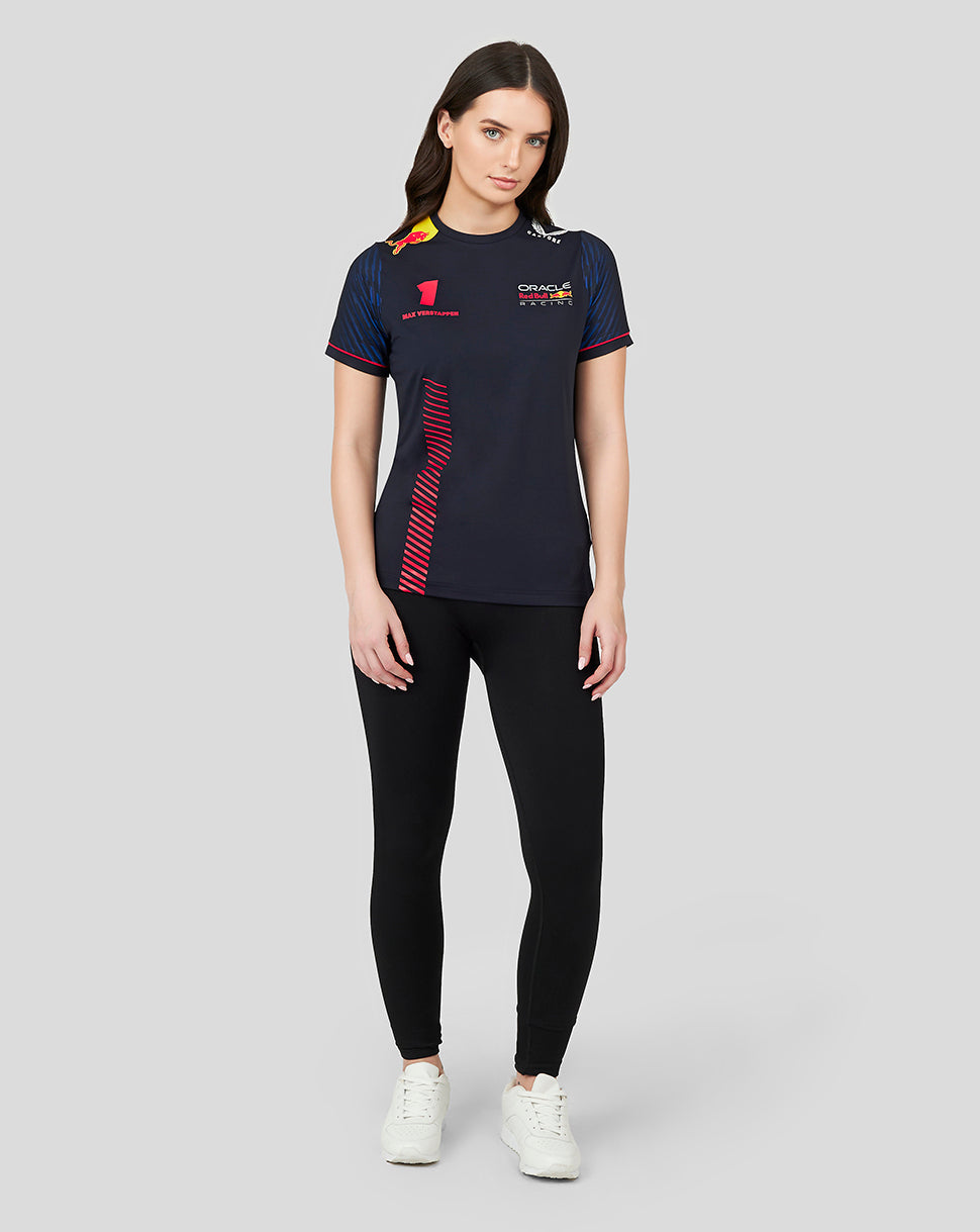 Full body shot of a woman wearing a navy Oracle Red Bull Racing T shirt with Max Verstappen number 1 and racing logos