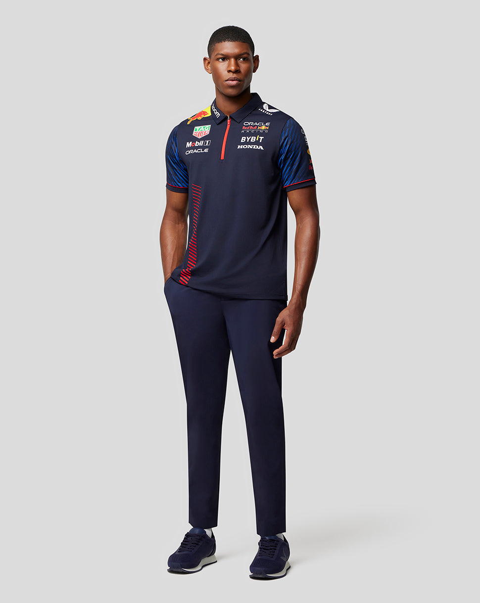 Male model wearing navy Oracle Red Bull Racing polo with sponsor logos on the chest