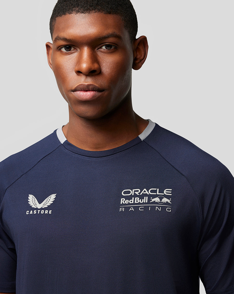 Close up of navy Night Sky Oracle Red Bull Racing shirt showing Castore logo and racing crest on the chest.