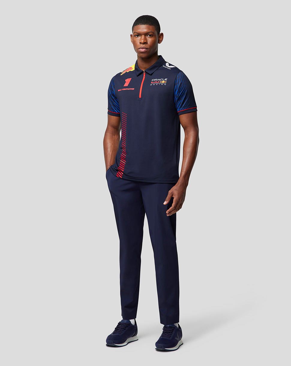 Full length view of a male model wearing a navy Oracle Red Bull Racing polo with red placket and number 1 on the chest.