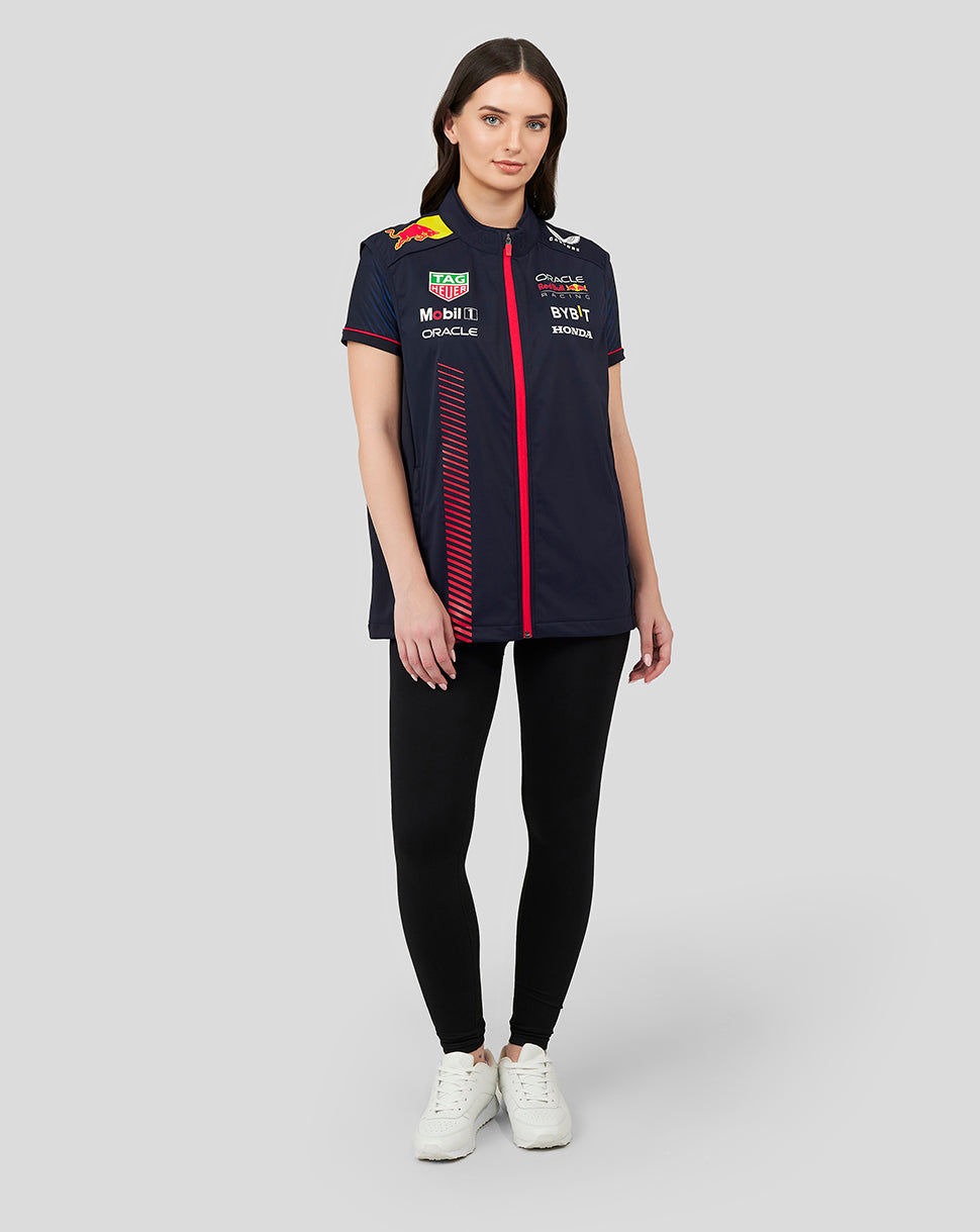 Female model wearing a navy Oracle Red Bull Racing Replica Hybrid Gilet with red zip and sponsor logos