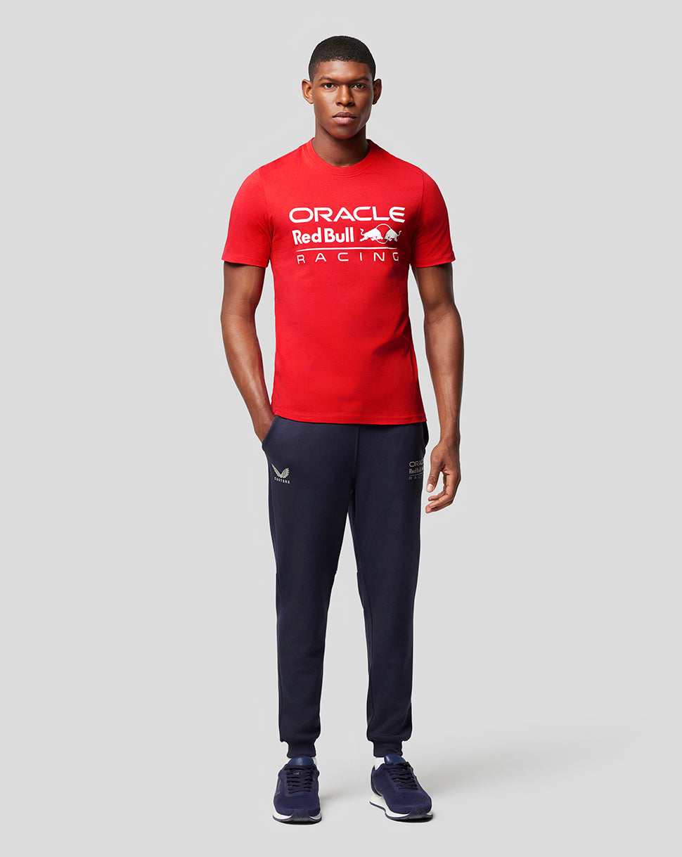 Male model in flame red Oracle Red Bull Racing T-shirt with white logo and navy joggers