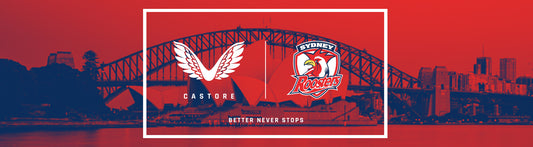 Castore wings logo on left and Sydney Roosters crest on right over a red Sydney skyline.