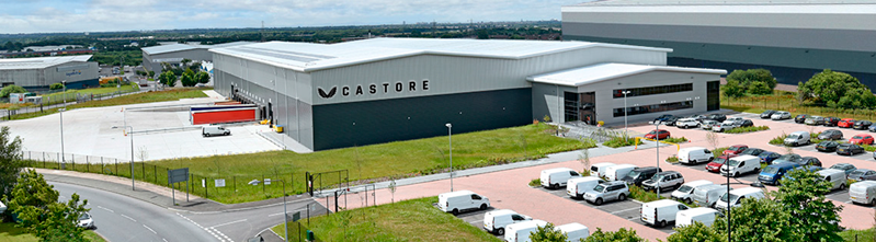 Aerial view of Castore automated distribution centre with loading bays and adjacent parking lot.