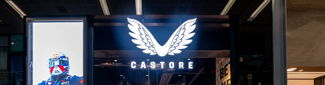 Castore store entrance with a large illuminated wing logo above the CASTORE sign.