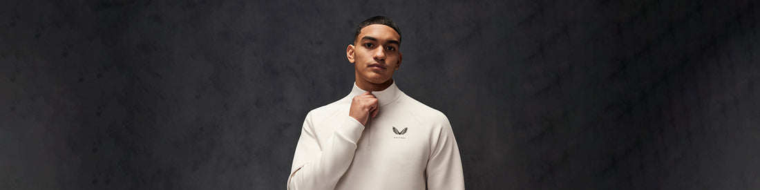 Male model in a cream turtleneck against a dark studio backdrop promoting the scuba collection