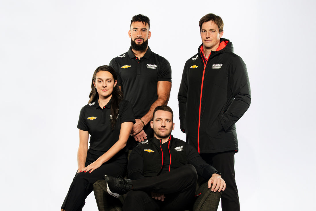Castore Hendrick Motorsports team portrait with four athletes in black uniforms