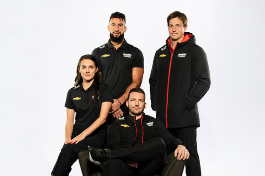 Castore Hendrick Motorsports team portrait with four athletes in black uniforms