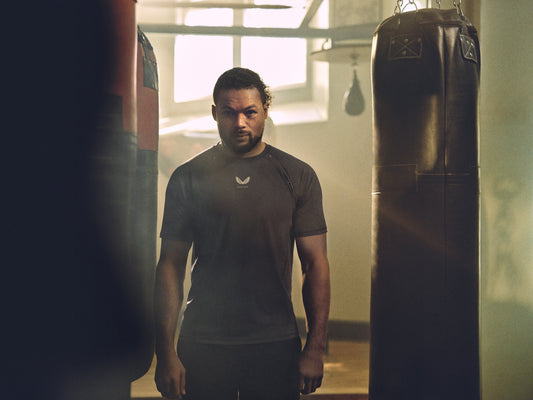 Joe Joyce in a gym near a hanging punching bag promotes Castore boxing partnership