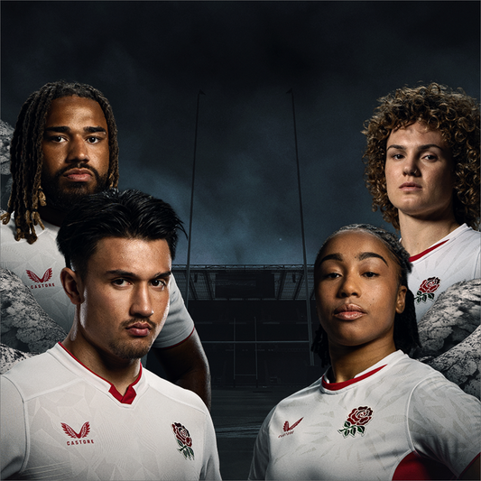 England rugby players in white jerseys with red rose crests stand together in front of a stadium under a dark sky.