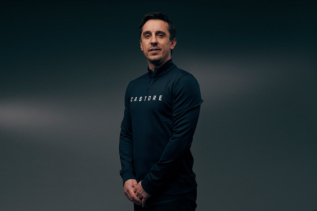Man wearing a navy Castore athletic top poses for a press photo.