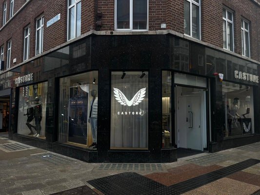 Exterior of the Castore concept store on Grafton Street with winged logo display in a large window.