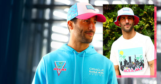 Two male models wear the Miami collection, featuring a turquoise hoodie with Oracle Red Bull Racing logo and a pink and blue cap