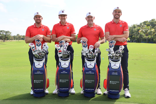 Four rugby players in red polo shirts stand with their gear and golf bags on a sunny golf course