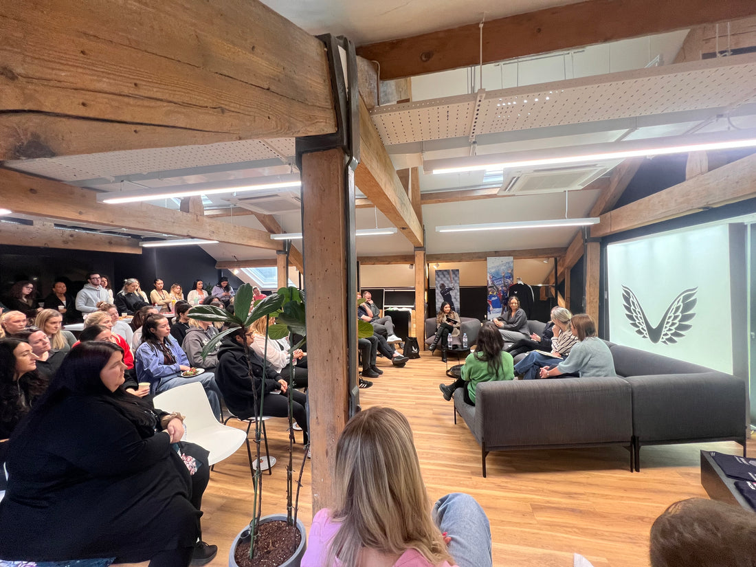 Audience seated in a loft style office with exposed timber beams at Castore head office for International Women’s Day.