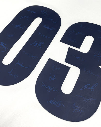 Close up of blue signatures on a dark blue number graphic from the Champions 2003 Replica Jersey