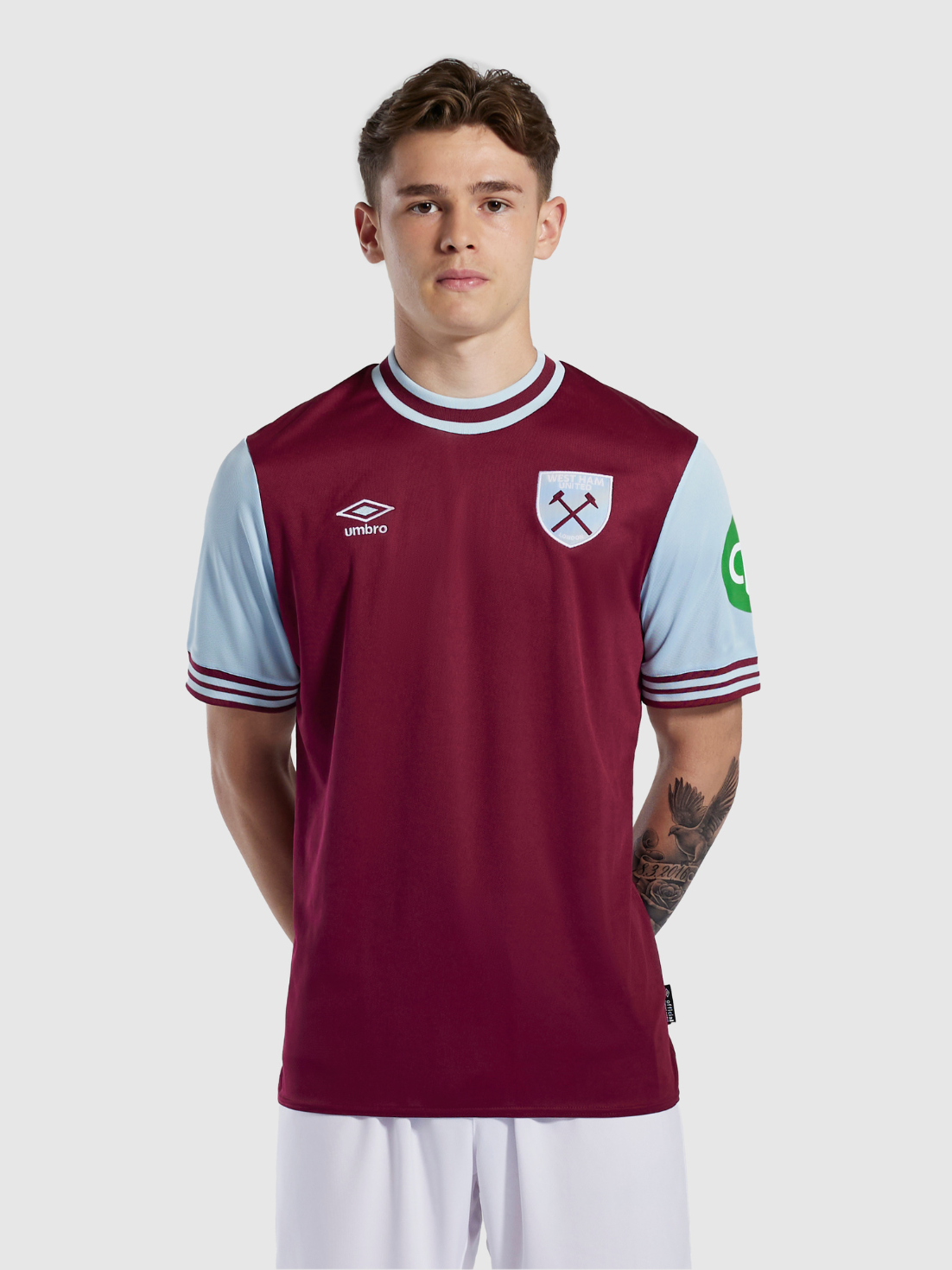 Junior West Ham 24/25 Home Jersey in burgundy with light blue sleeves and white trim worn by a young model
