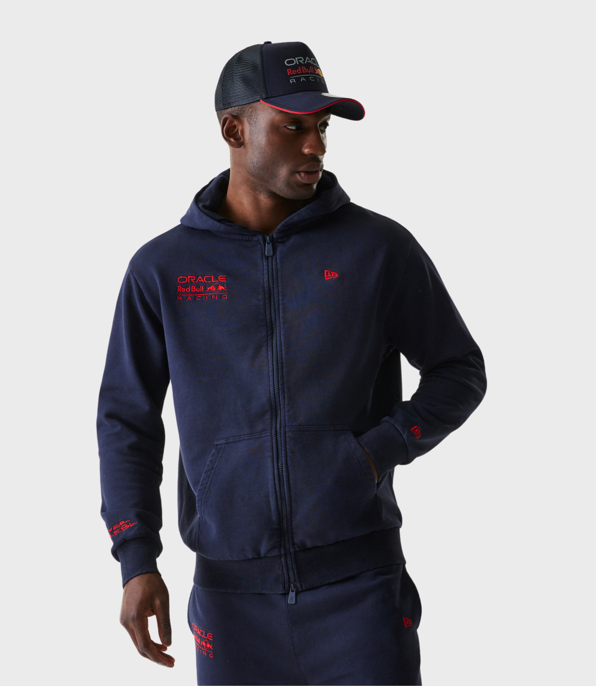 Man wearing navy oversized zip hoodie with Oracle Red Bull Racing chest patch and New Era emblem on chest and sleeve