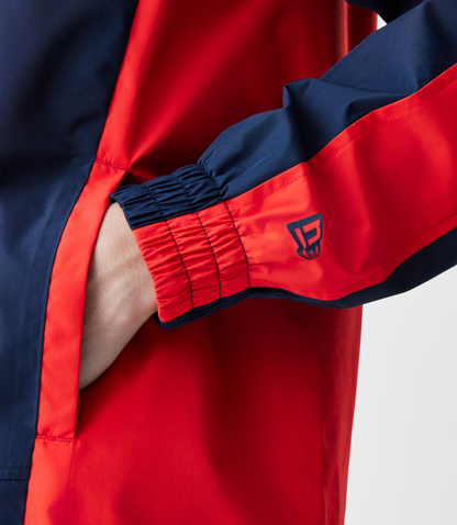 Rear view of navy Red Bull Racing Windrunner jacket with bold Red Bull wordmark on back.