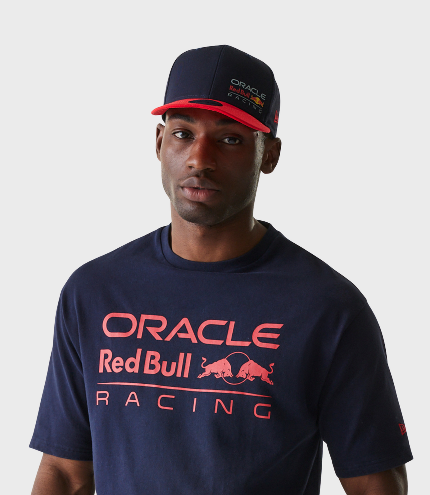 Portrait of a man wearing a navy cap with the Oracle Red Bull Racing logo on the front