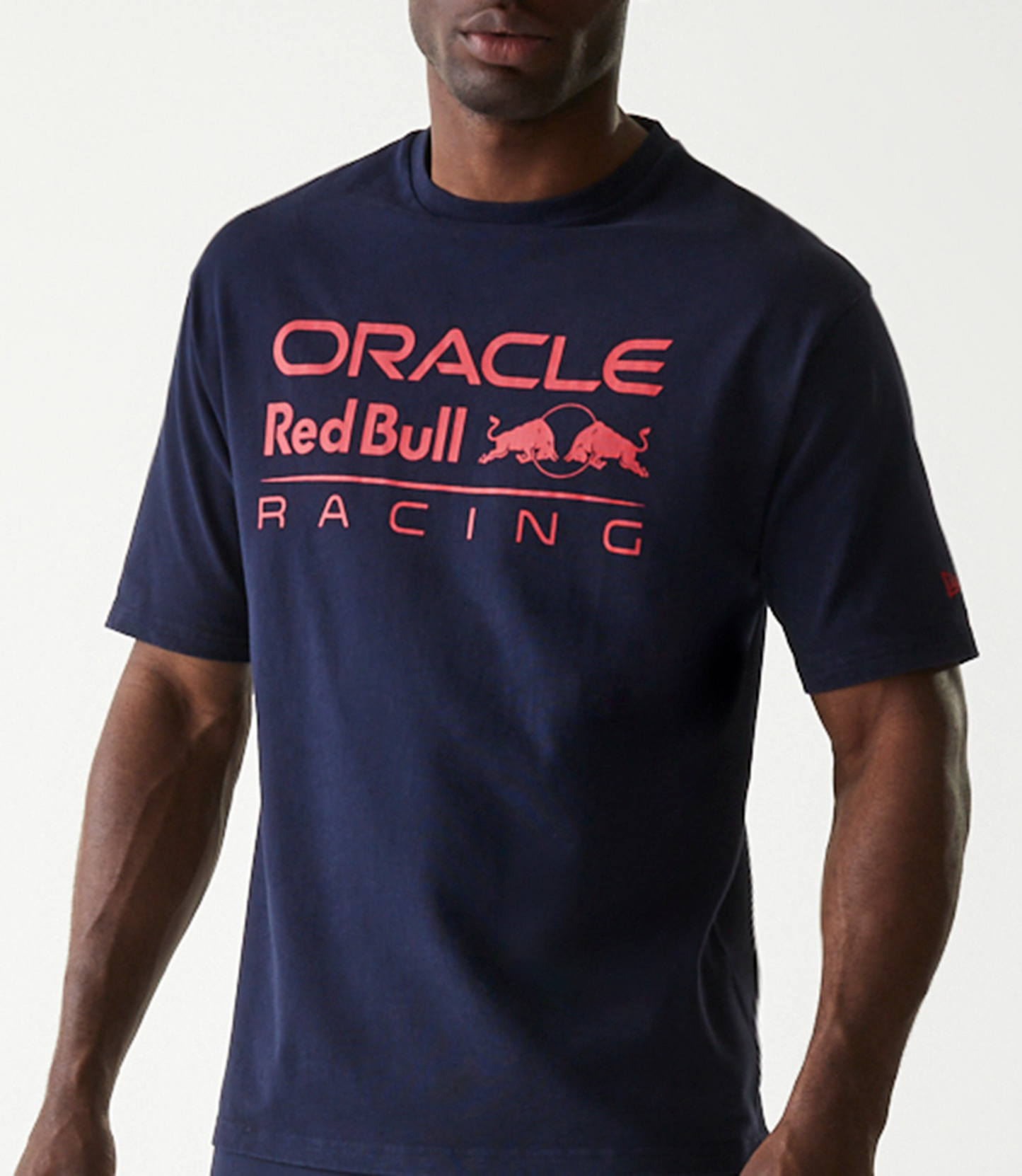 Front view of a navy oversized T shirt with a bold pink Oracle Red Bull Racing logo across the chest.