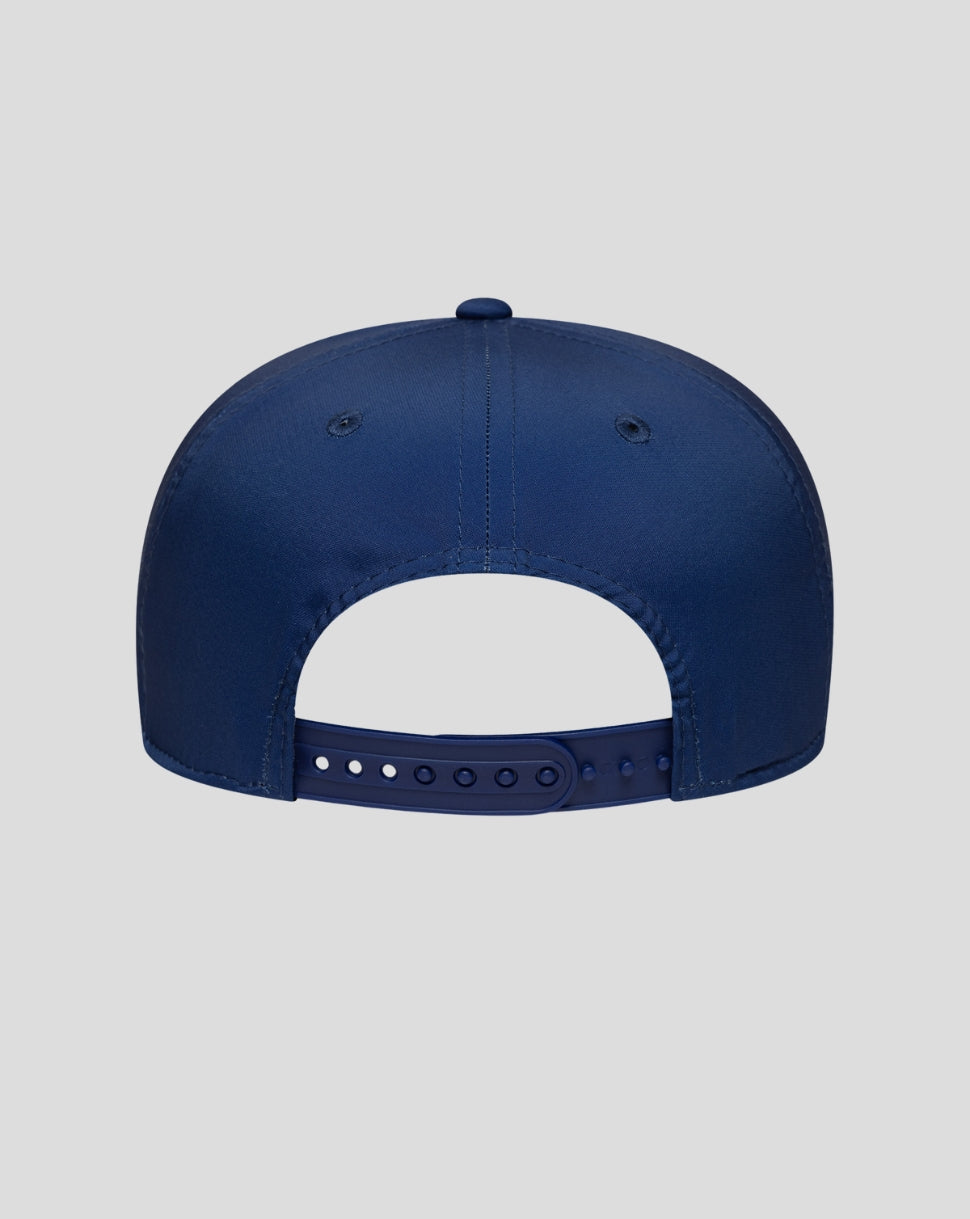 Rear view of a blue New Era 9Seventy Stretch Snap Cap with an adjustable snapback strap and top button.