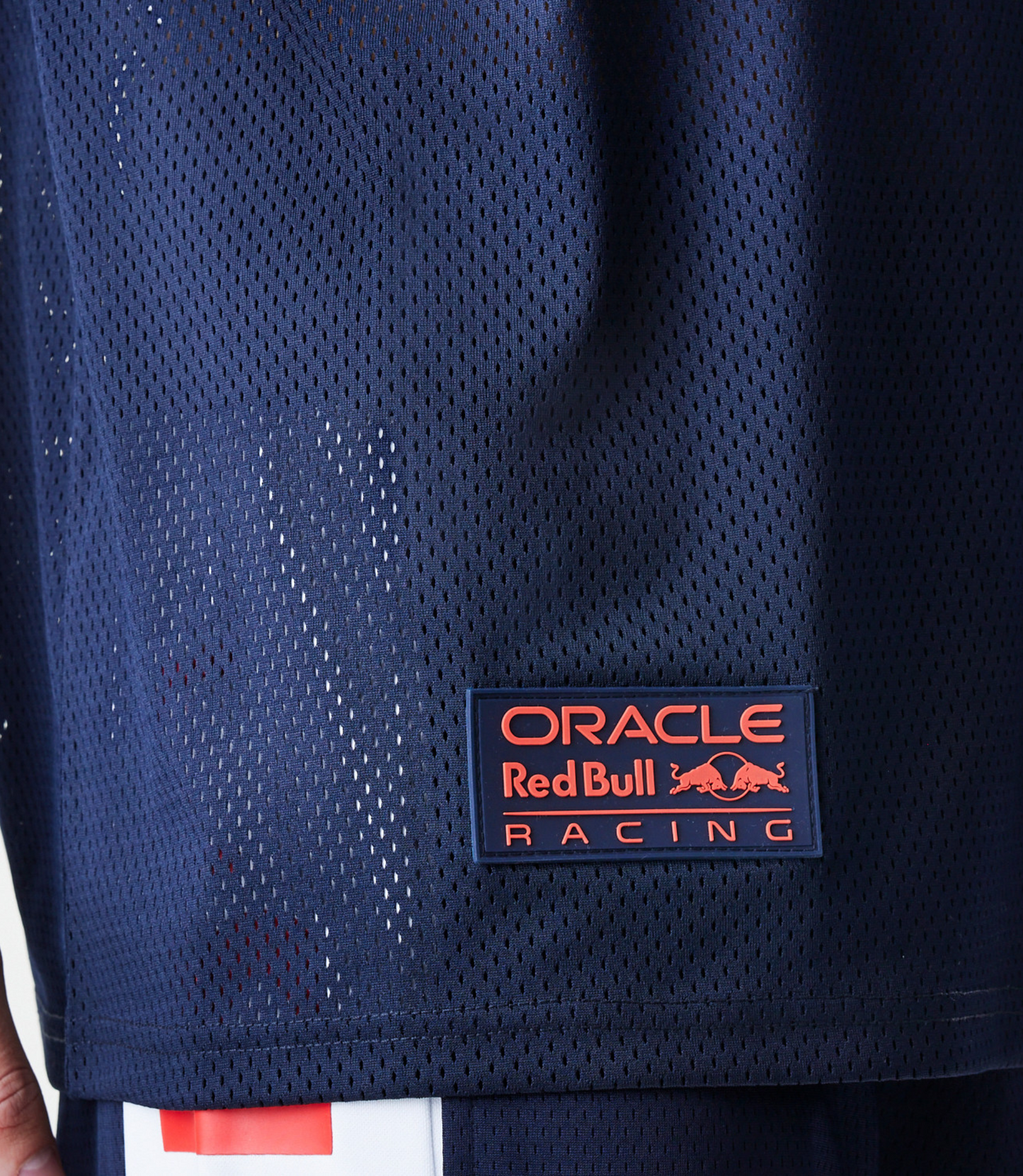 Male model wearing a navy blue oversized mesh T shirt with Oracle Red Bull Racing branding