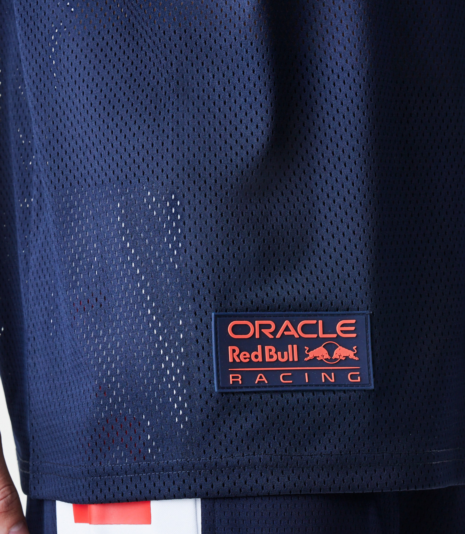 Male model wearing a navy blue oversized mesh T shirt with Oracle Red Bull Racing branding