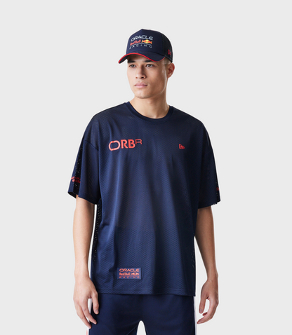 Man wearing a navy mesh T shirt with Oracle Red Bull Racing logo on chest and a navy cap with red brim