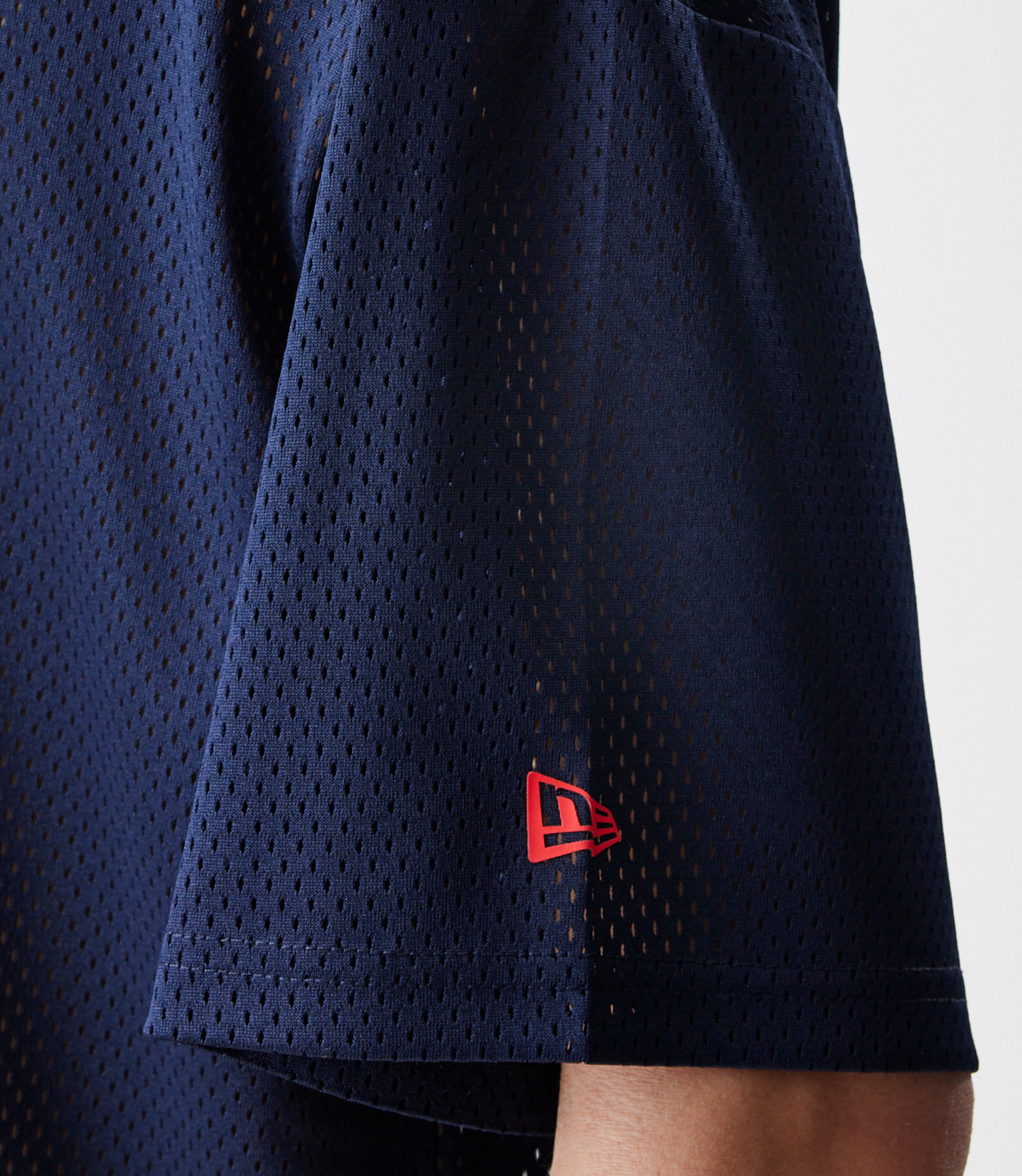 Close up of dark blue breathable mesh fabric from a racing T shirt
