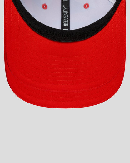 Front view of a red curved brim cap with a black inner edge along the face opening.