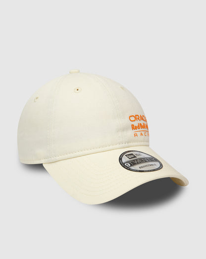 Angled side view of cream Red Bull Racing 9Twenty cap with orange embroidery and curved visor