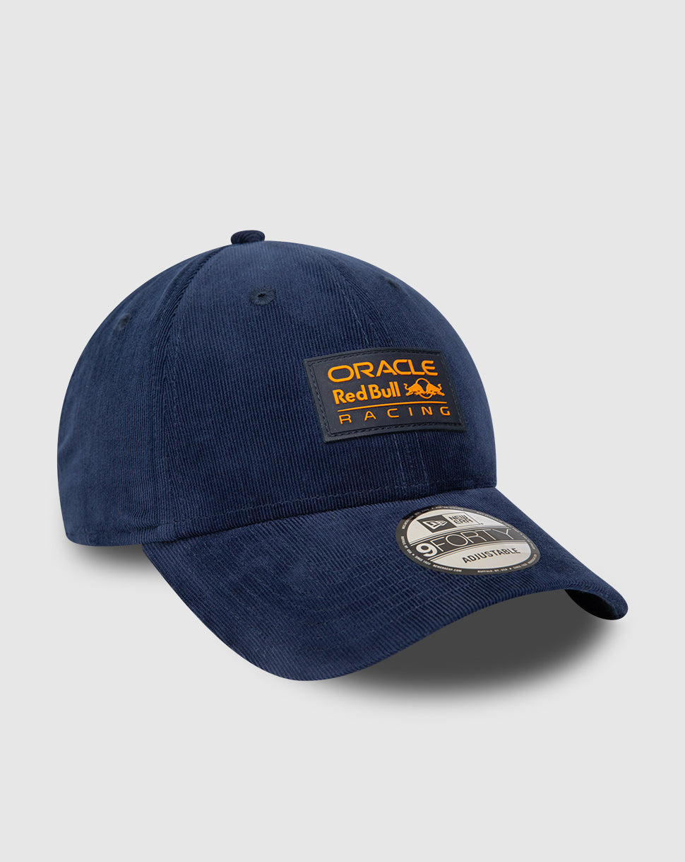 Angled shot of navy Red Bull Racing 9FORTY cap showing orange patch on front and curved visor