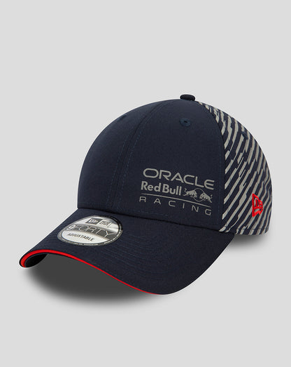 Navy New Era 9Forty cap with Oracle Red Bull Racing Las Vegas branding on the front and a diagonal striped back panel with a red brim edge.