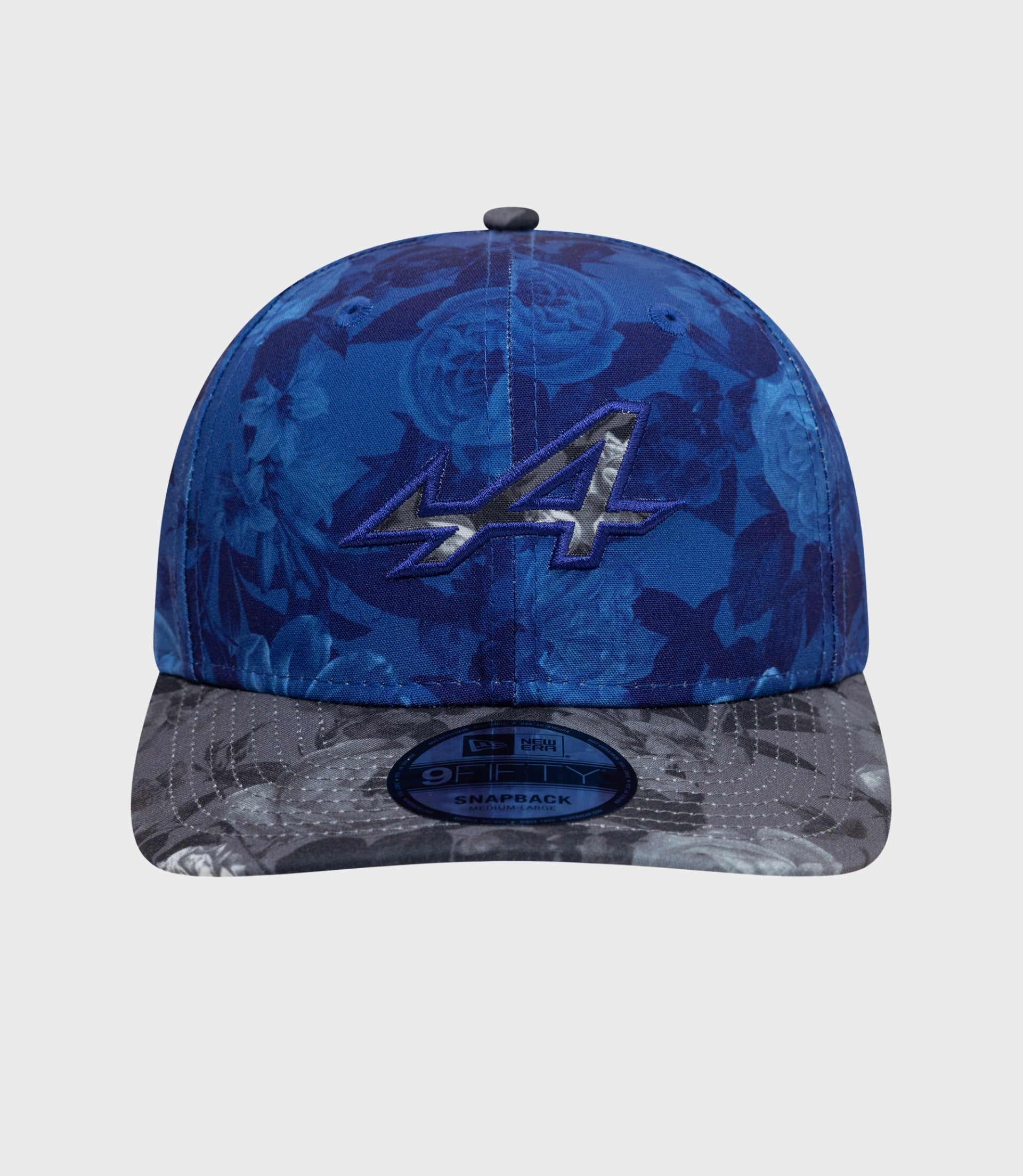 Blue floral New Era Alpine 9Fifty cap with gray camo brim and visible 9FIFTY sticker on the brim