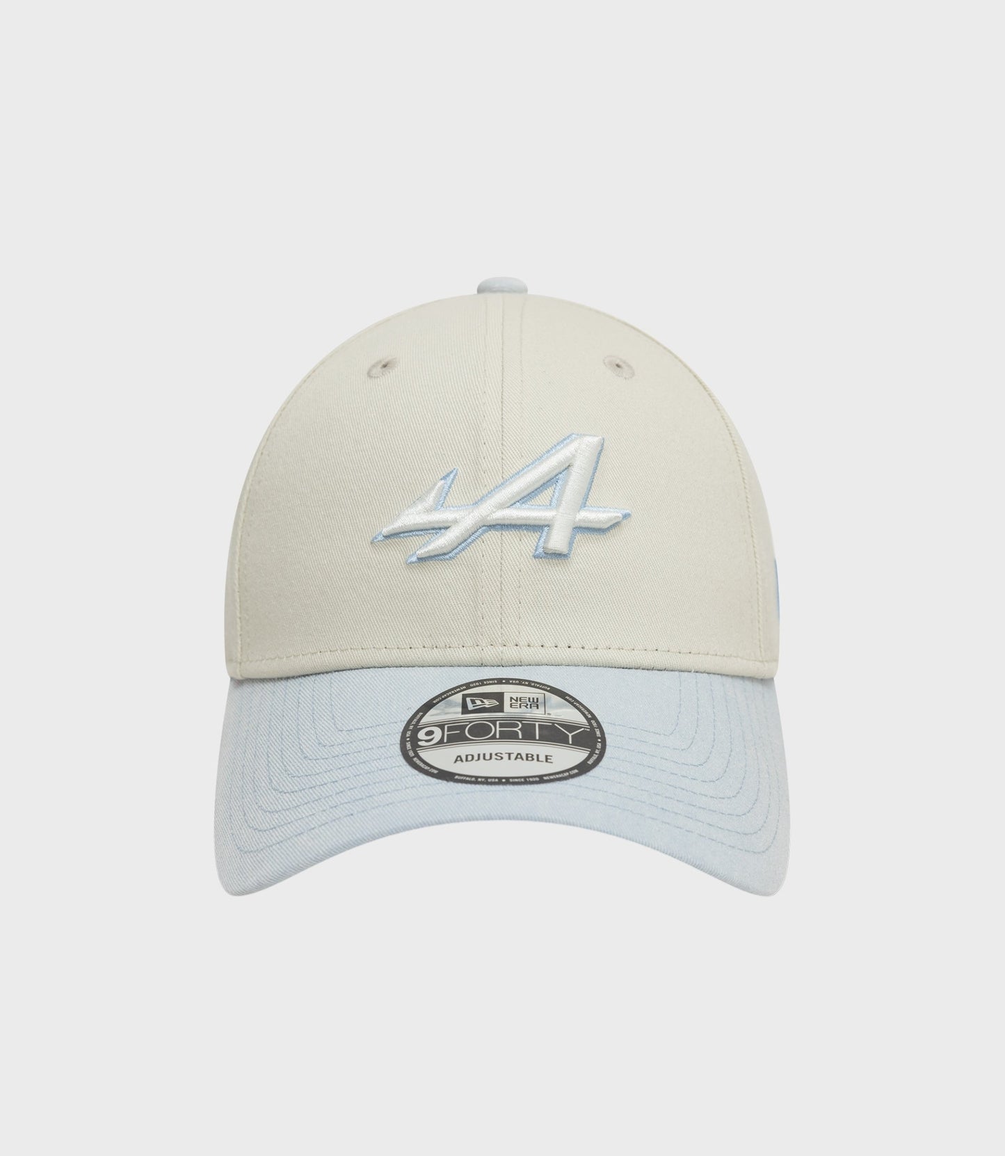 Front view of creme New Era Alpine Acid Wash 9Forty cap with light blue denim brim and pale blue embroidery on crown