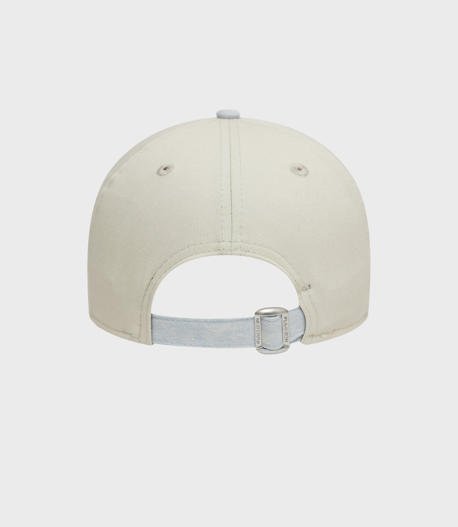 Back view of creme New Era Alpine Acid Wash 9Forty cap showing denim strap buckle and light blue brim