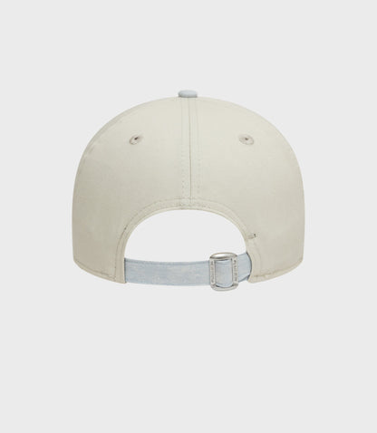 Back view of creme New Era Alpine Acid Wash 9Forty cap showing denim strap buckle and light blue brim
